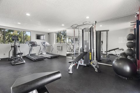 A spacious home gym with a variety of equipment.