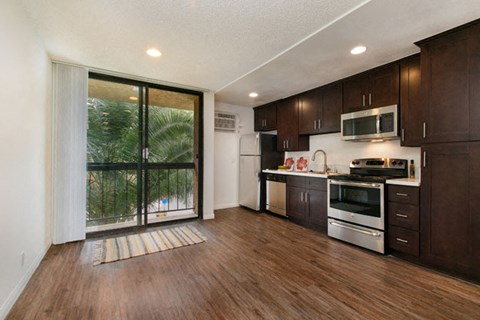 a kitchen with a large window and a stove and a sink