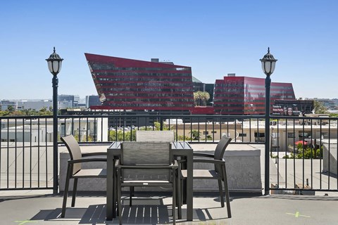 a patio with a table and chairs on a balcony