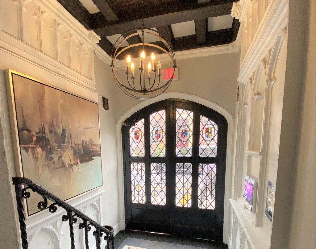 a view of a staircase with a window and a chandelier