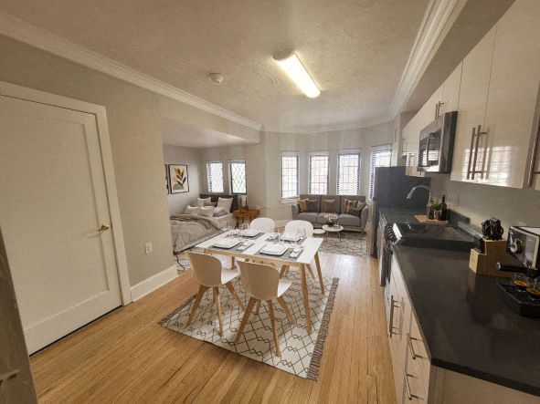 a kitchen and living room with a table and chairs