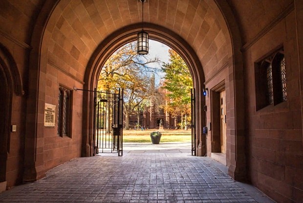 the archway of a building with a brick sidewalk