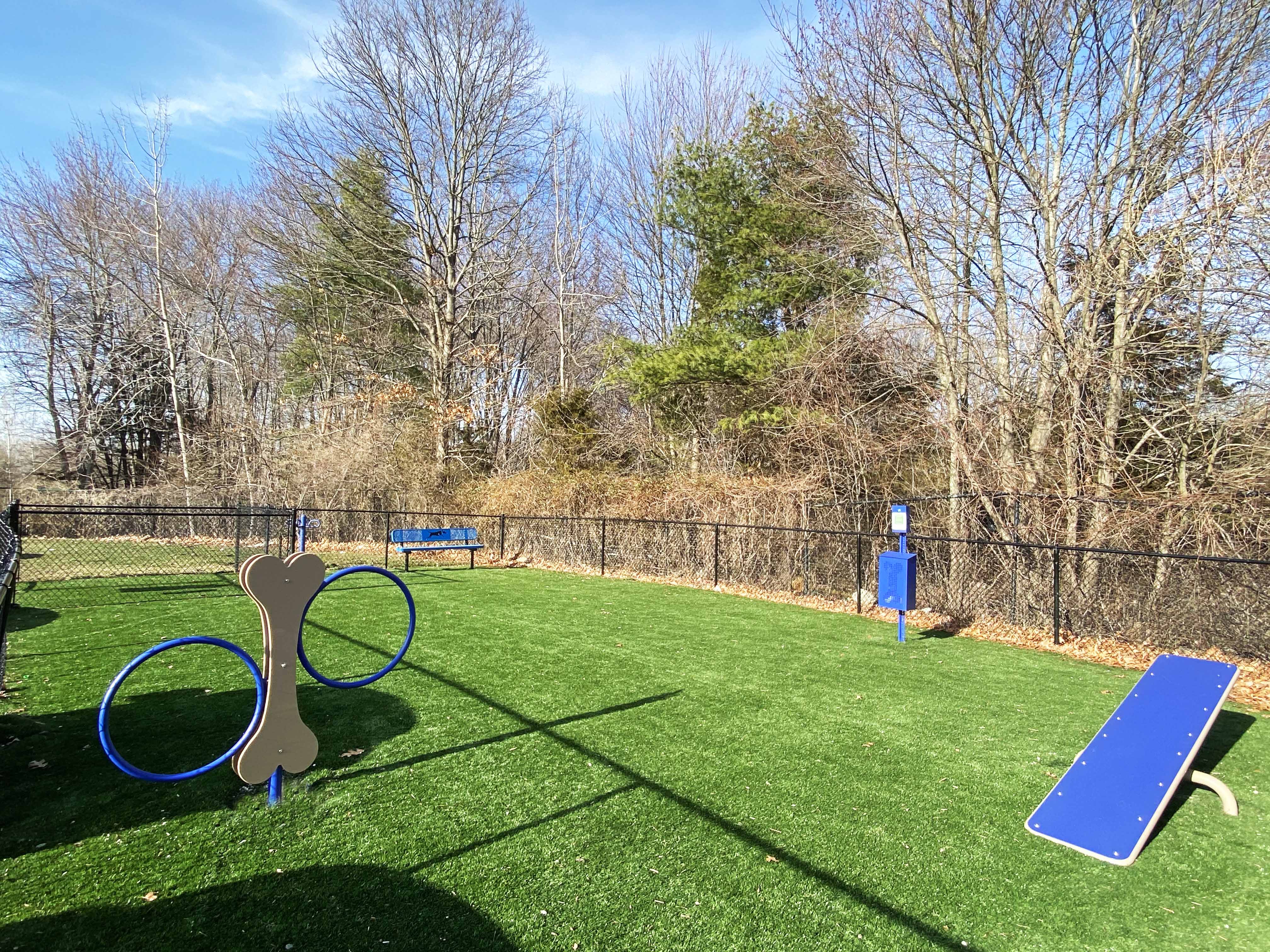 a playground with a blue bench and a pair of scissors
