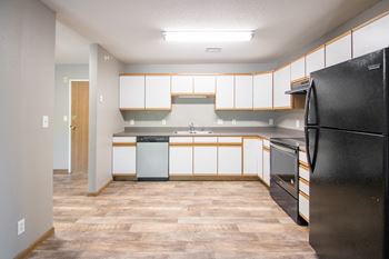 Fully Equipped Kitchen Including Refrigerator, Range, Dishwasher, and Microwave