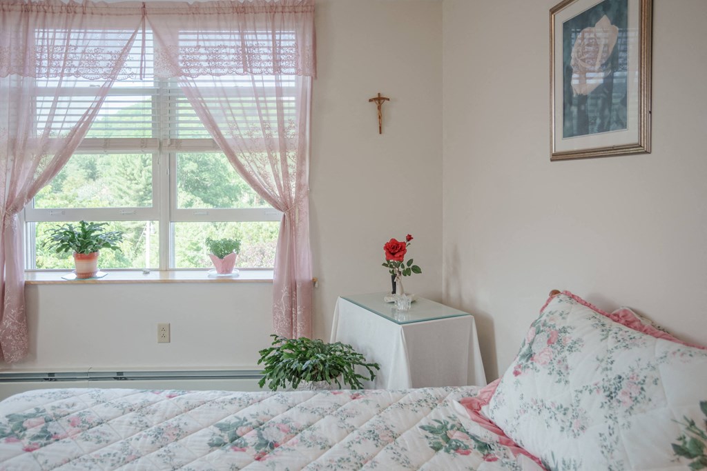 a bedroom with a bed and a window
