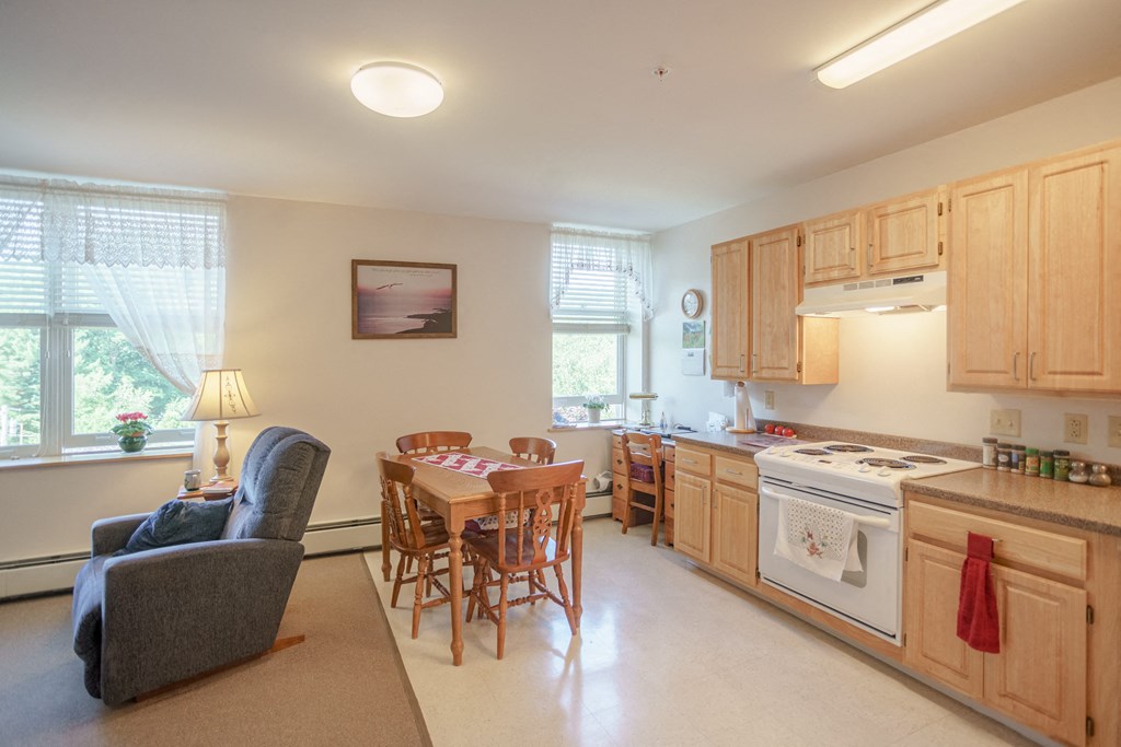 a kitchen and dining room with a table and chairs