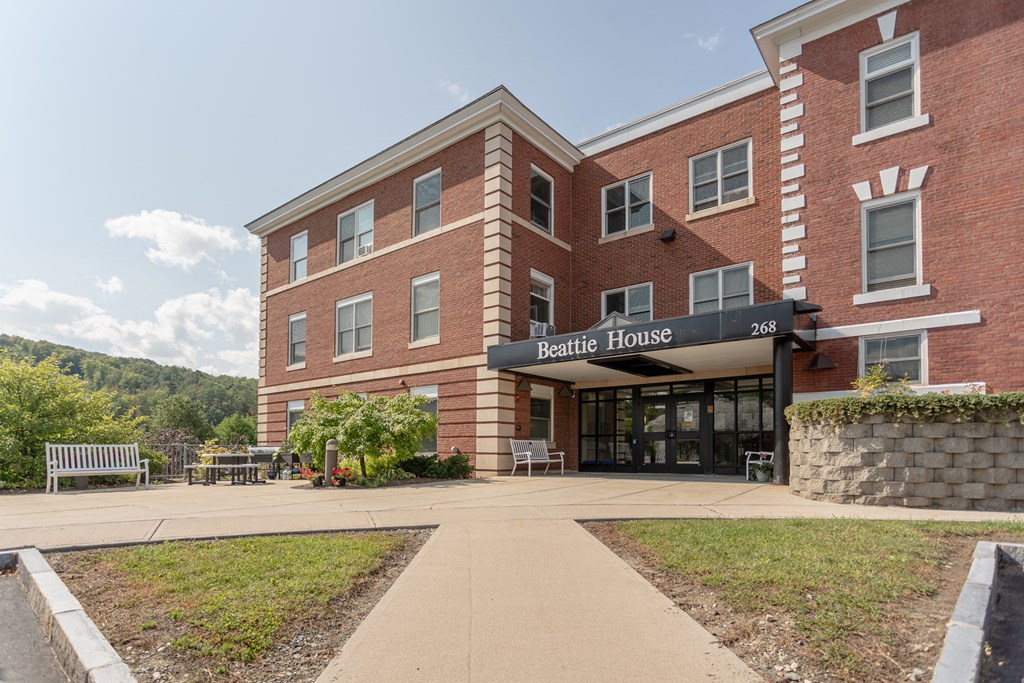 a brick building with a sidewalk in front of it