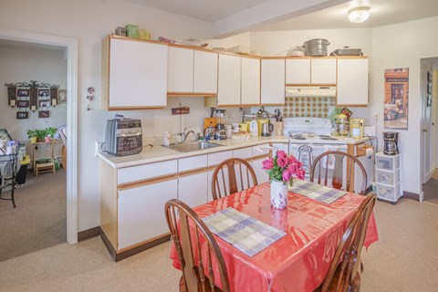 a kitchen and dining room with a table and chairs