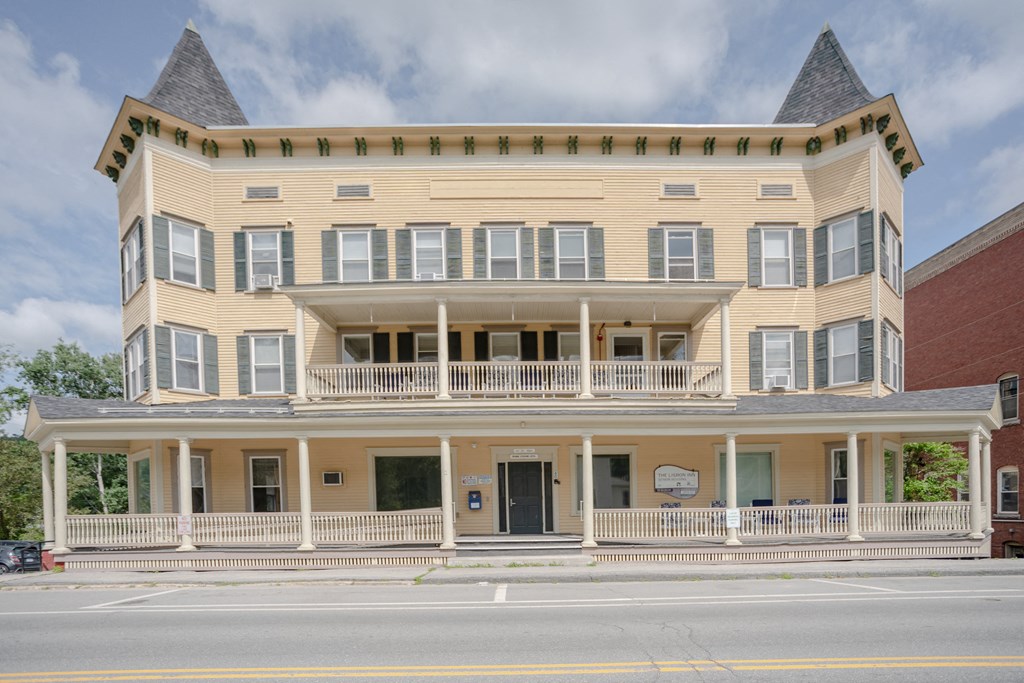 a large yellow building on the side of a street
