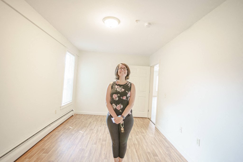 a woman standing in the middle of an empty room