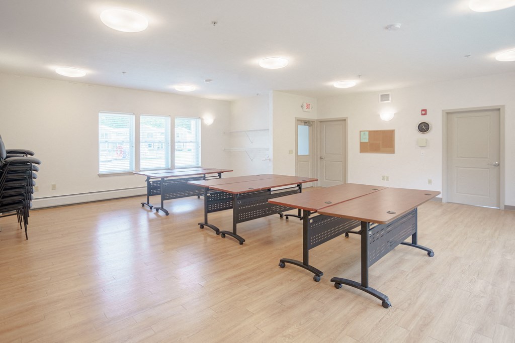 a dining room with tables and chairs in the center of the room