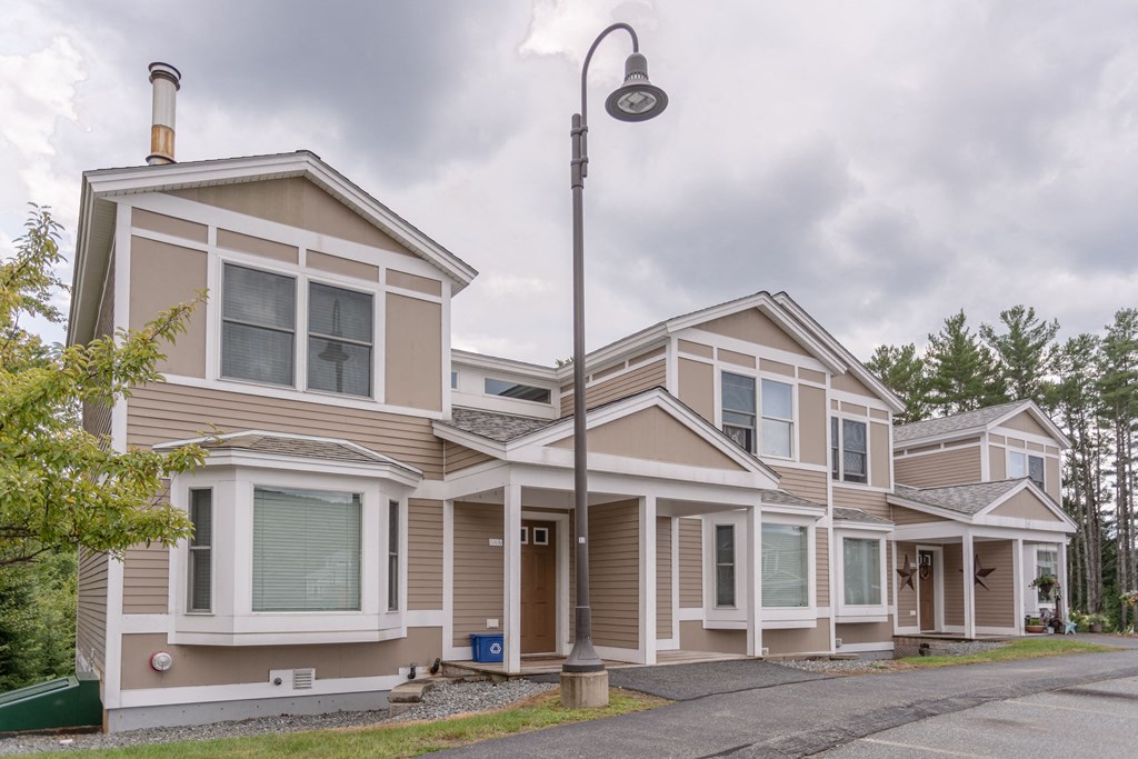 a row of houses with a street light in front of them
