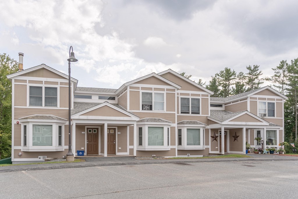 a street view of a house with a parking lot