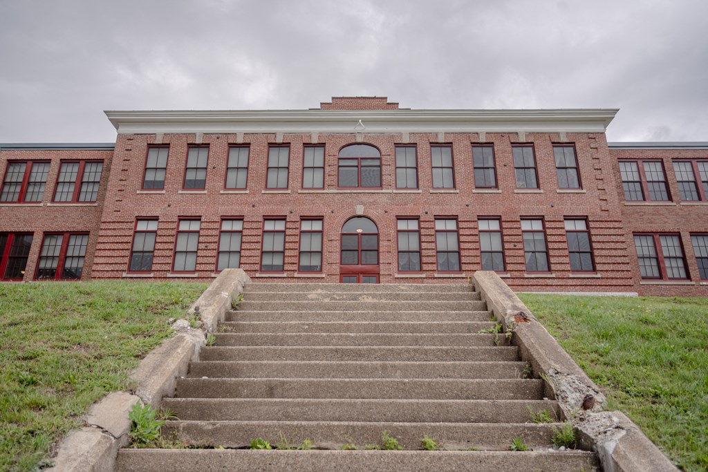 a large brick building with stairs in front of it