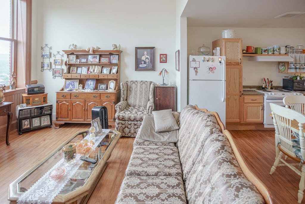 a living room and kitchen with a couch and a table