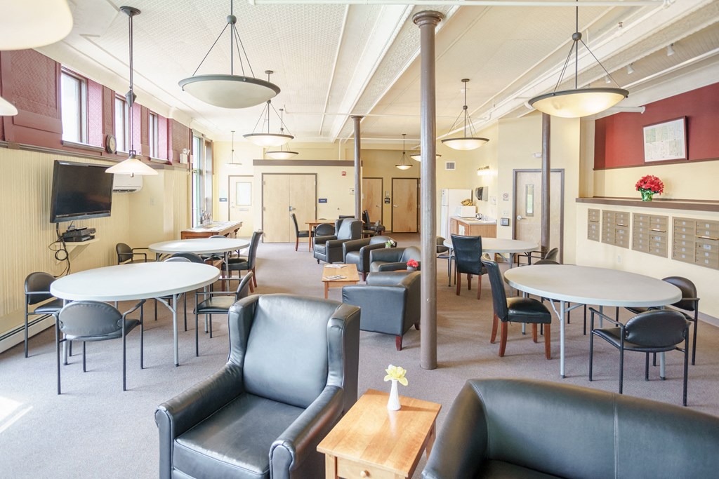 a large room filled with tables and chairs and couches