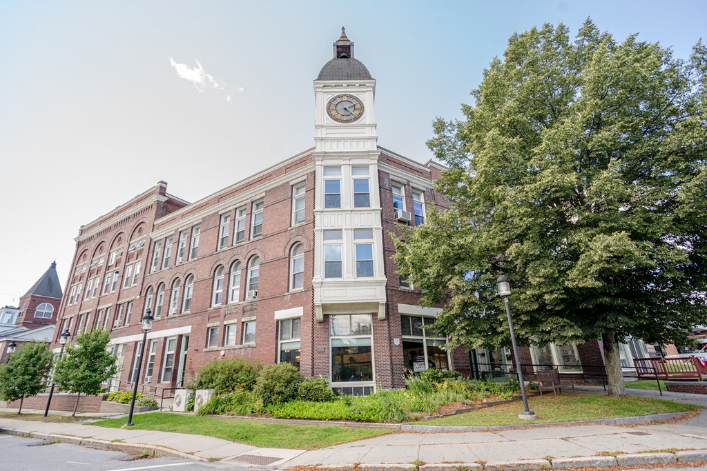 a large brick building with a clock tower on top