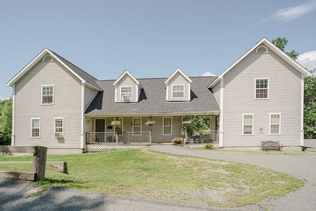 the front of a house with a yard and a driveway
