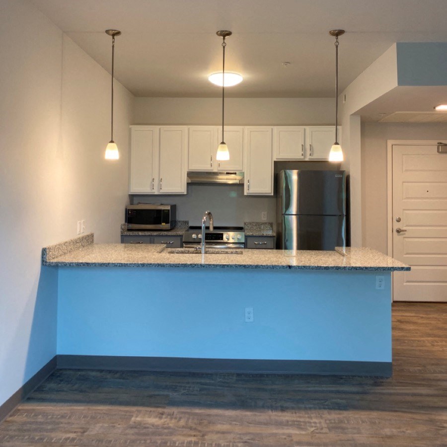 an empty kitchen with a blue counter top