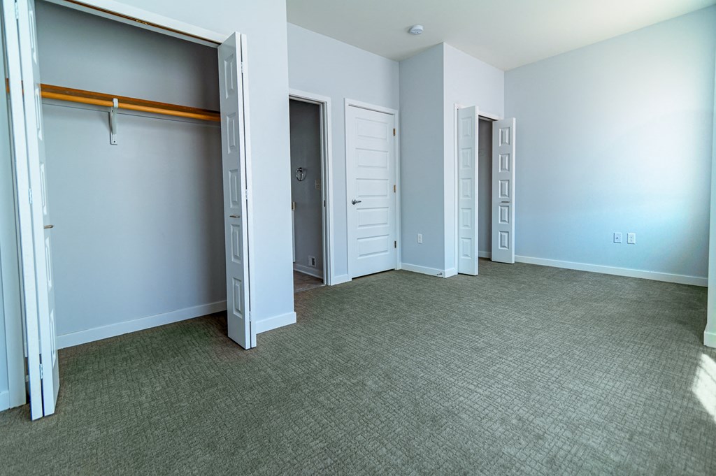 an empty room with three closets and three doors