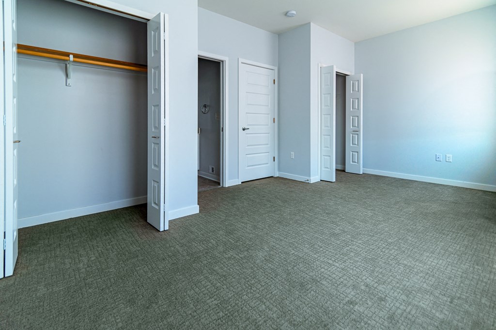 an empty room with blue walls and a closet