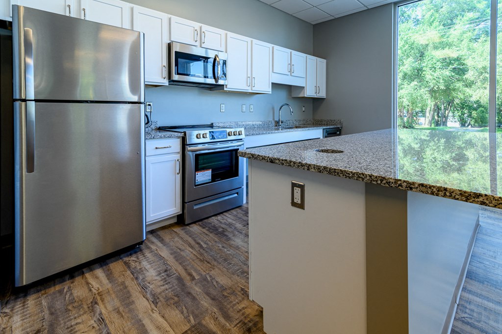 a kitchen with stainless steel appliances and a granite counter top