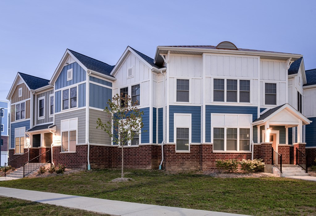 a row of blue and white homes on a sidewalk