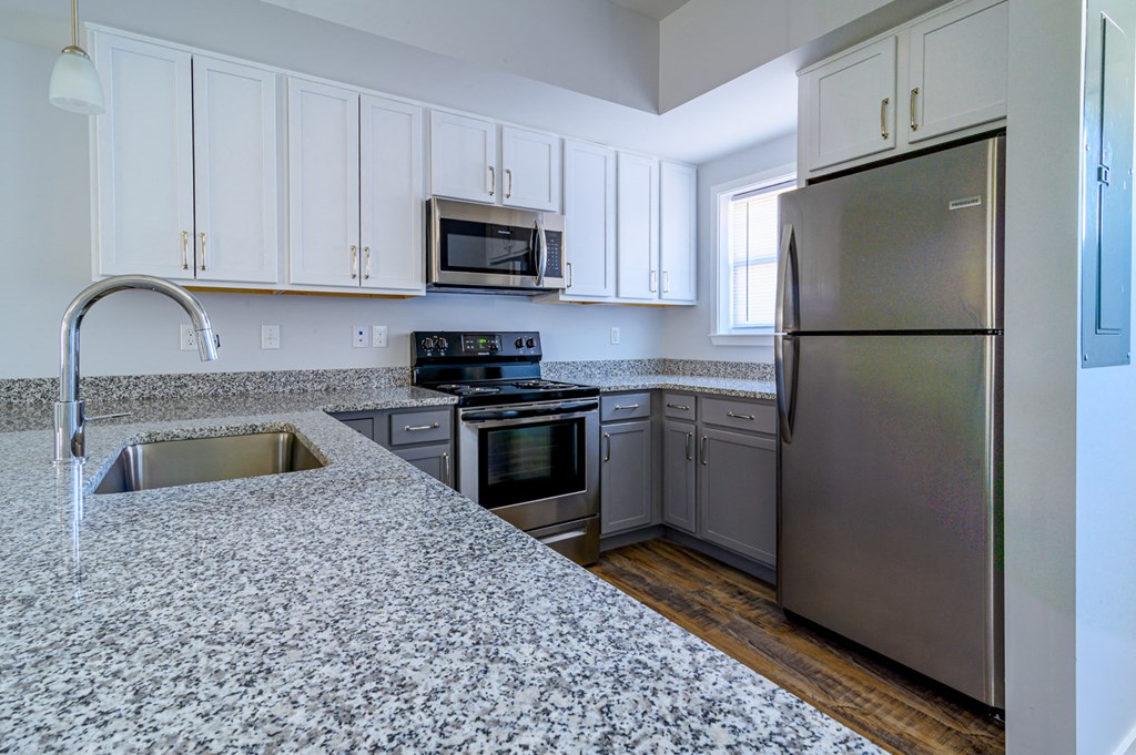 a kitchen with granite counter tops and stainless steel appliances