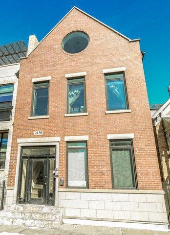 the front of a brick building with windows