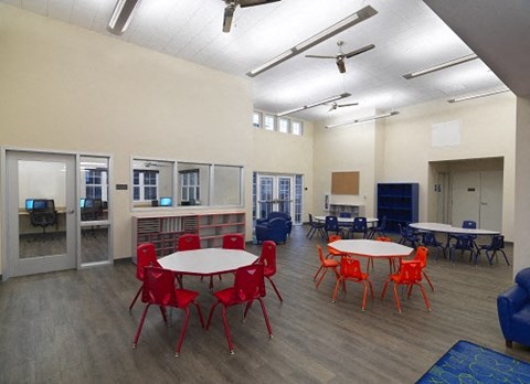 a dining room with tables and chairs in a classroom