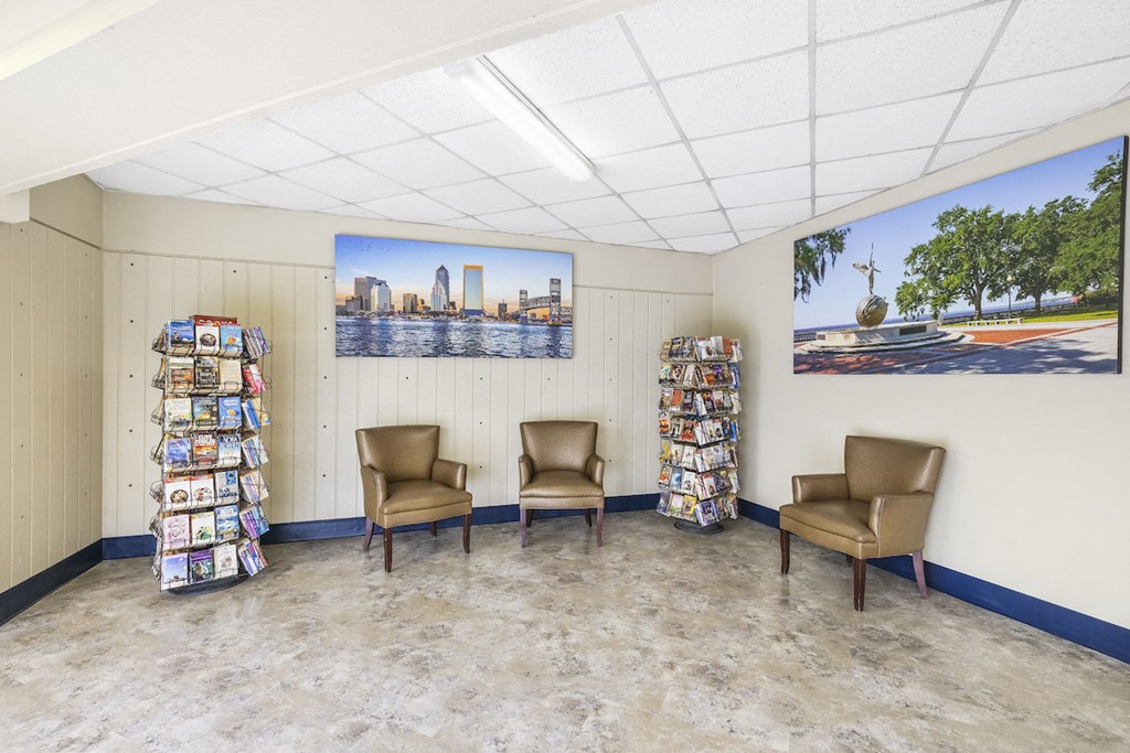 the waiting room of a library with chairs and shelves of books
