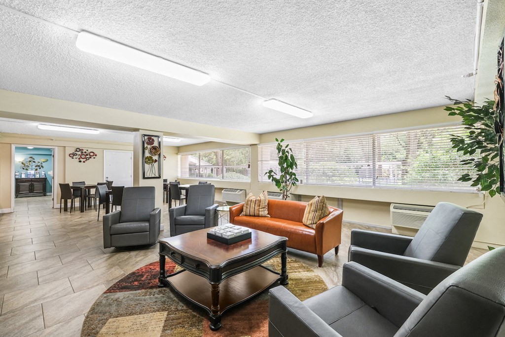 a living room with couches and chairs and a table