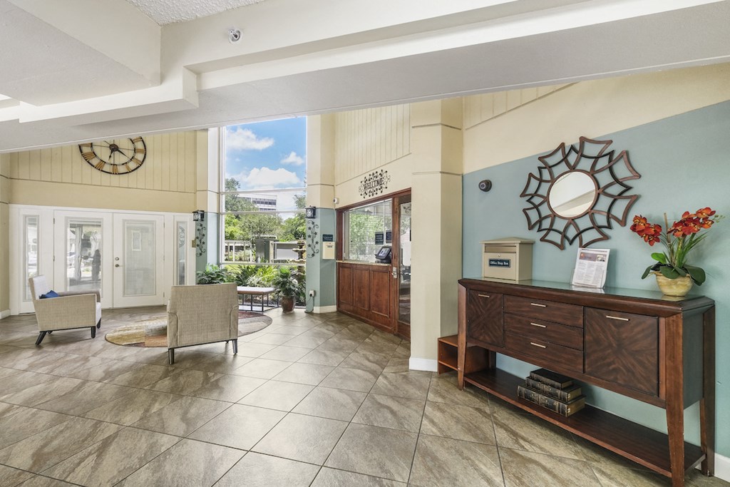 the lobby of a hotel with chairs and a reception desk