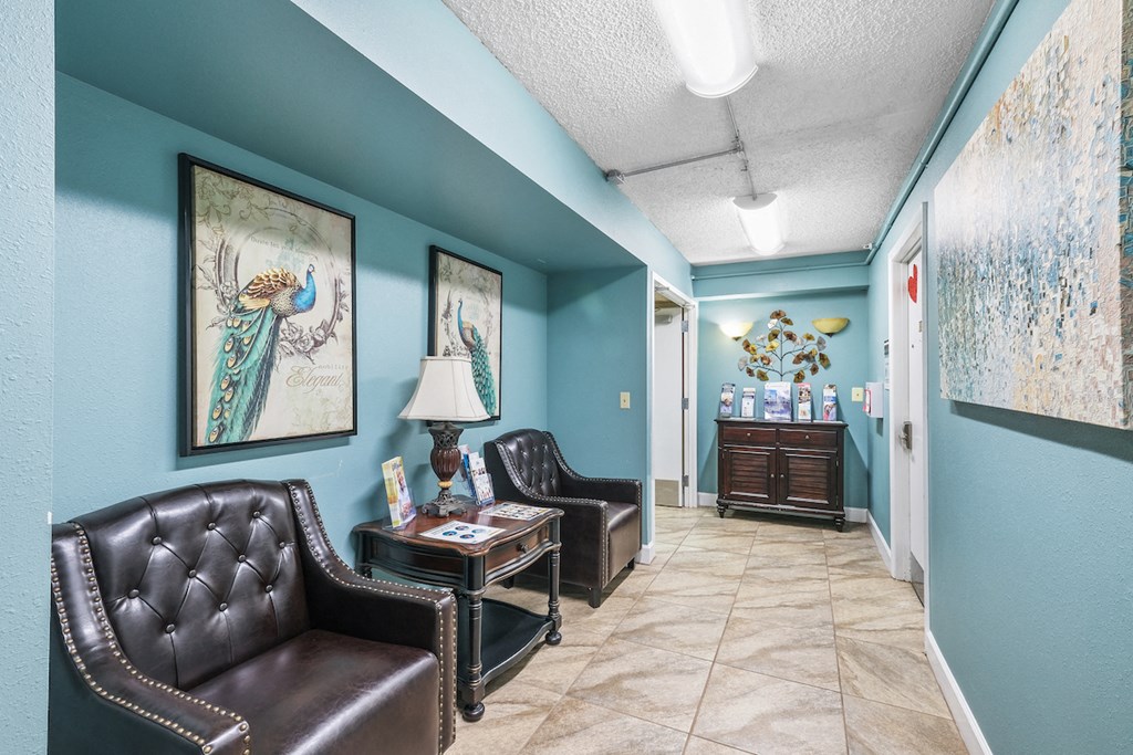 a living room with leather furniture and blue walls