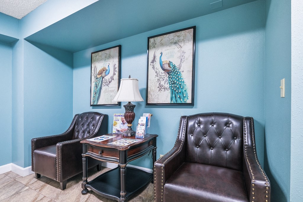 a living room with two leather chairs and a table