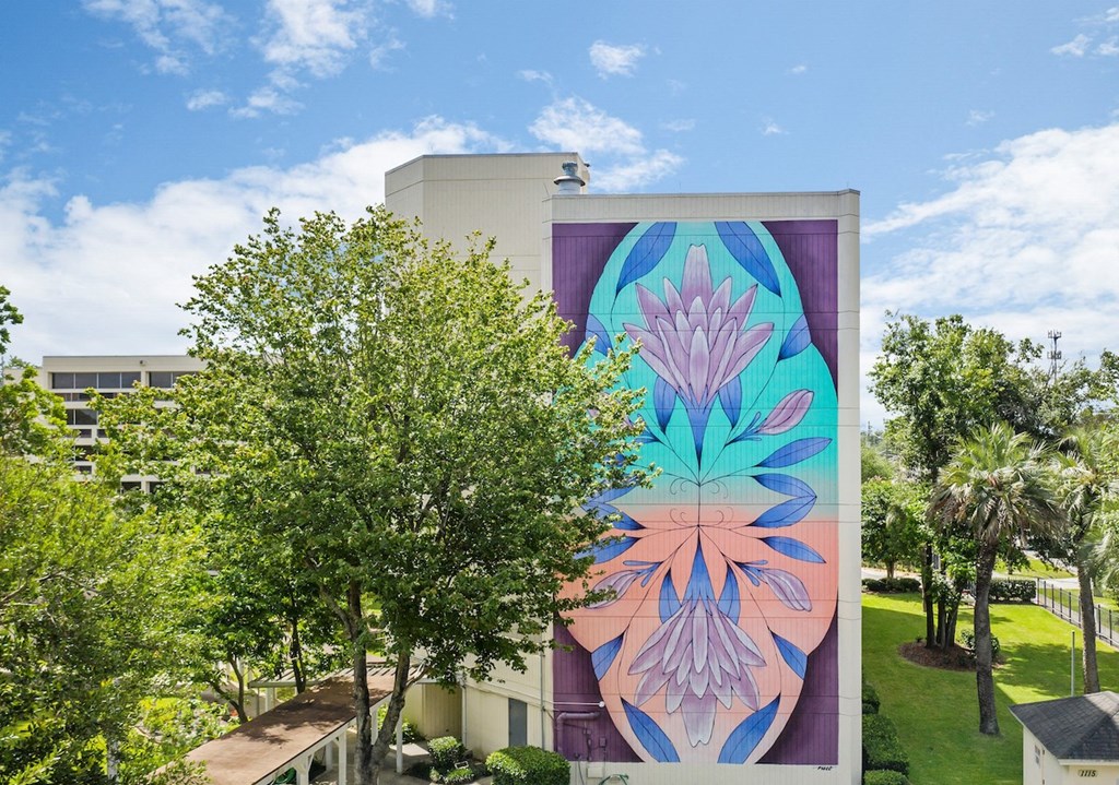 a mural of flowers on the side of a building