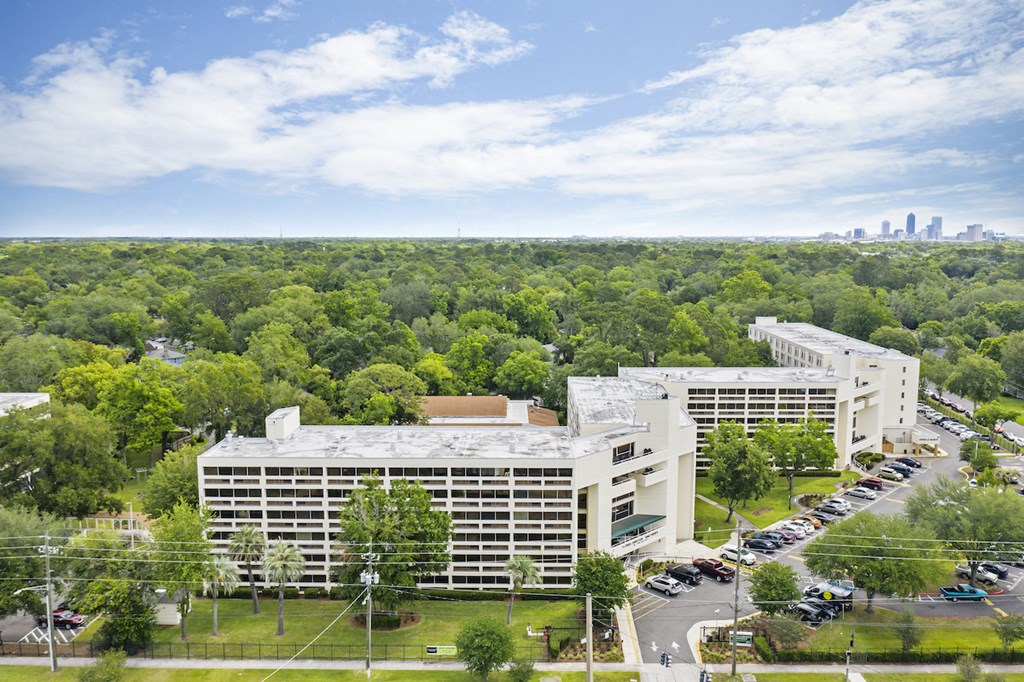 an aerial view of an office building with cars parked in a parking lot