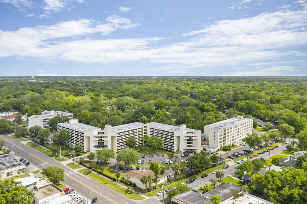 an aerial view of a city with tall buildings and trees