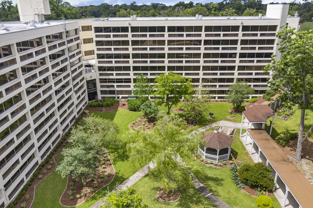 an aerial view of the courtyard of an office building with trees and grass