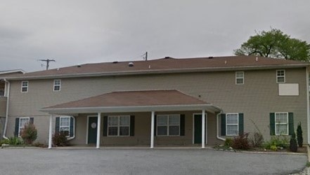 A house with a brown roof and a white door.