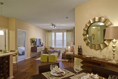 A dining room with a table set for a meal.