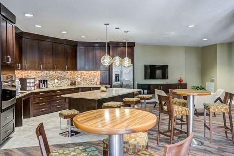 A modern kitchen with a wooden table and chairs.