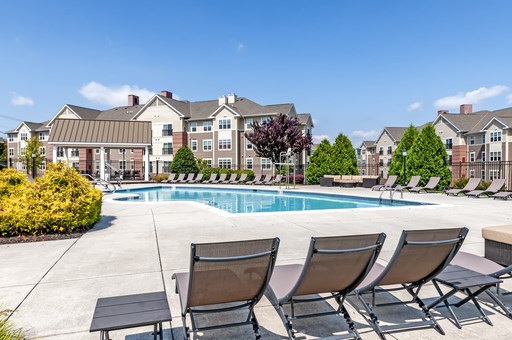 our apartments offer a swimming pool with chairs and tables