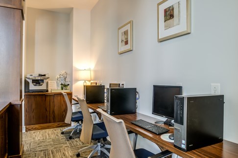 a computer room with three computer monitors on a desk