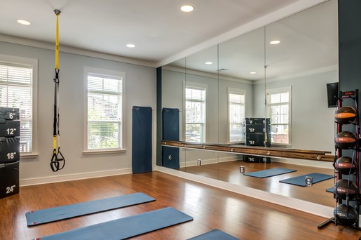 a yoga studio with mirrors and yoga mats on the floor