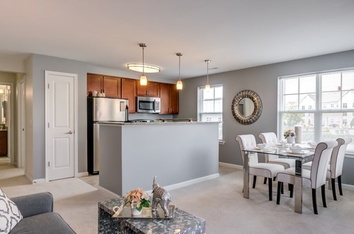 an open kitchen and dining room with a table and chairs