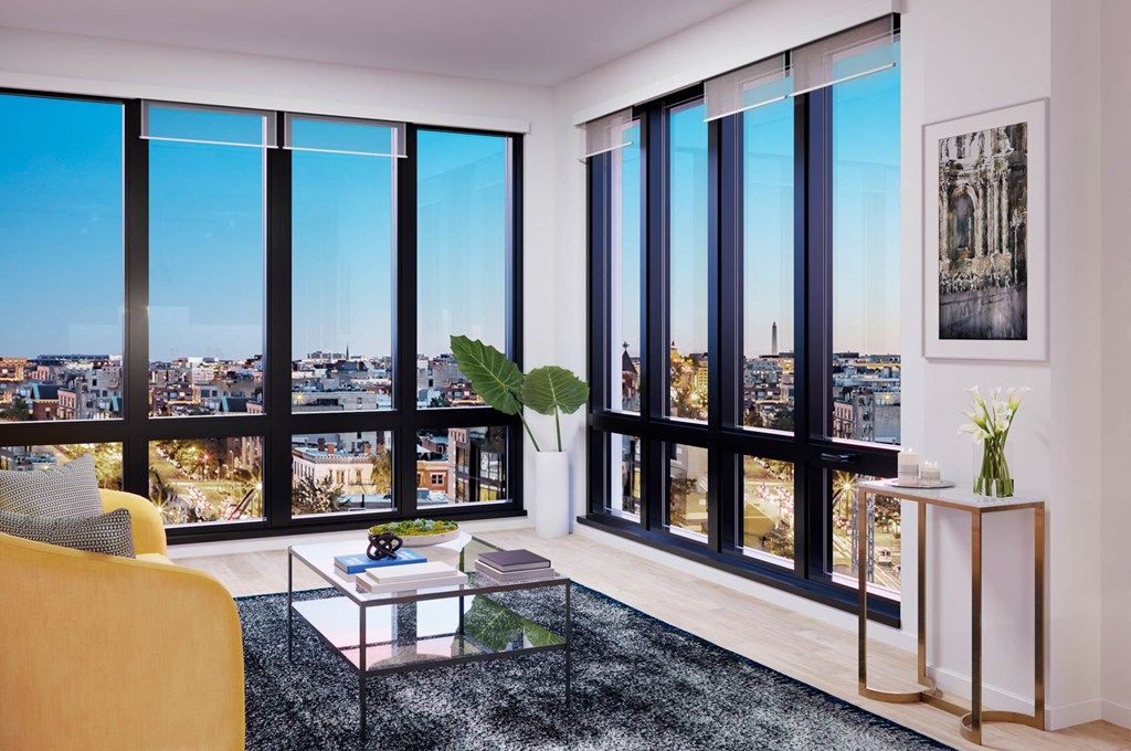 a living room with a view of the city and skyscrapers