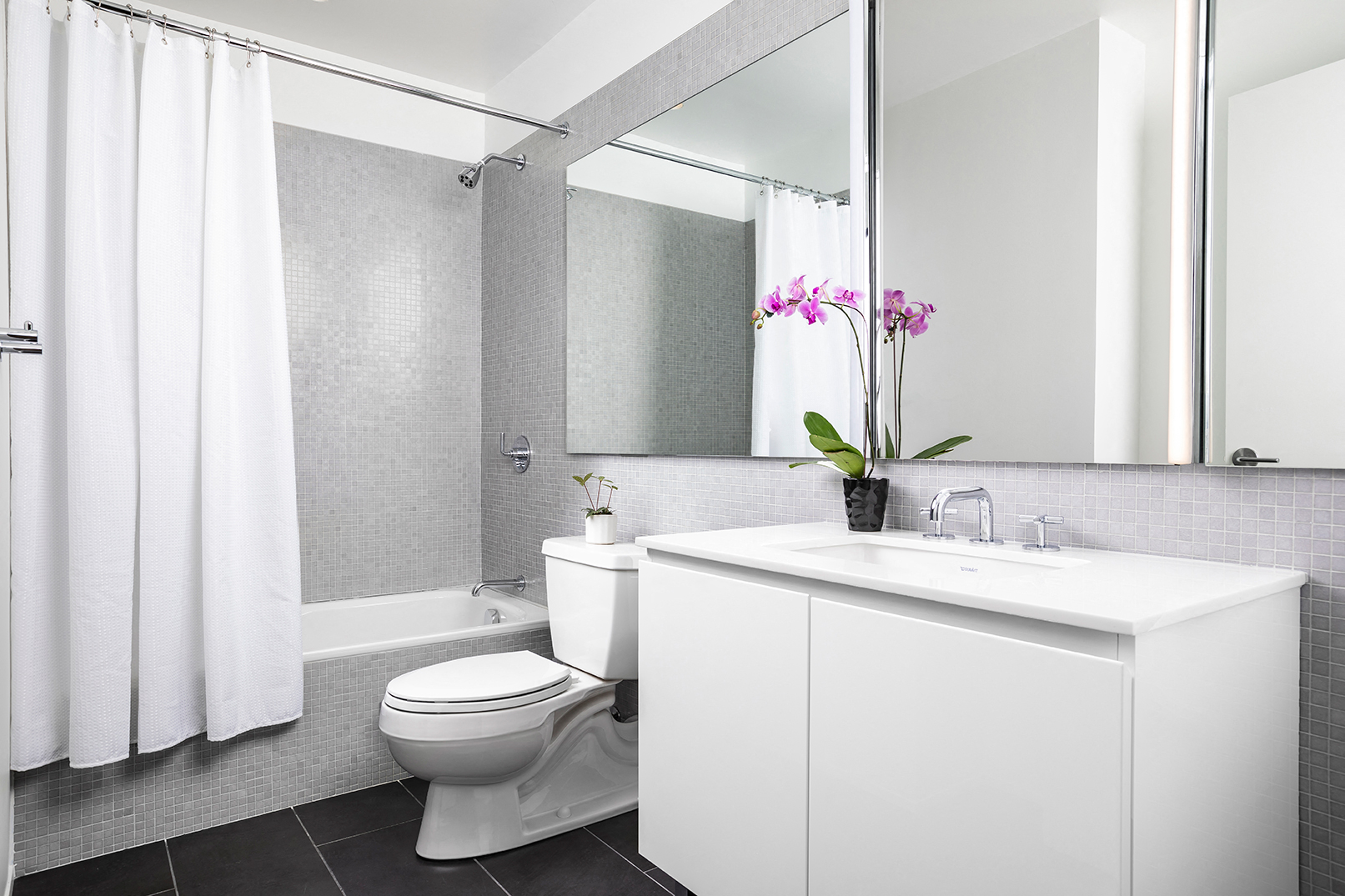 a bathroom with a toilet and a sink and a mirror