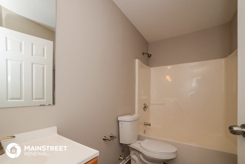 a small bathroom with a toilet and a shower