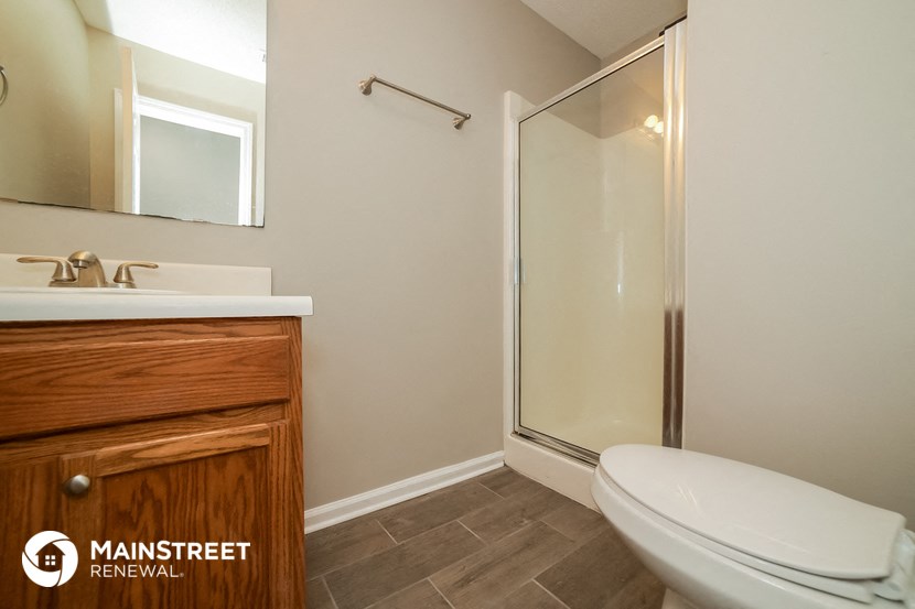 a bathroom with a toilet sink and a shower